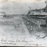 This undivided back postcard shows the bathing beach and bathhouses.
